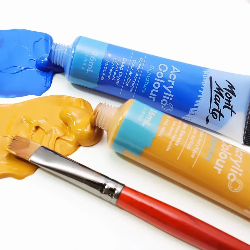 Mont Marte acrylic paint tubes, blue and yellow paint with brush on white background